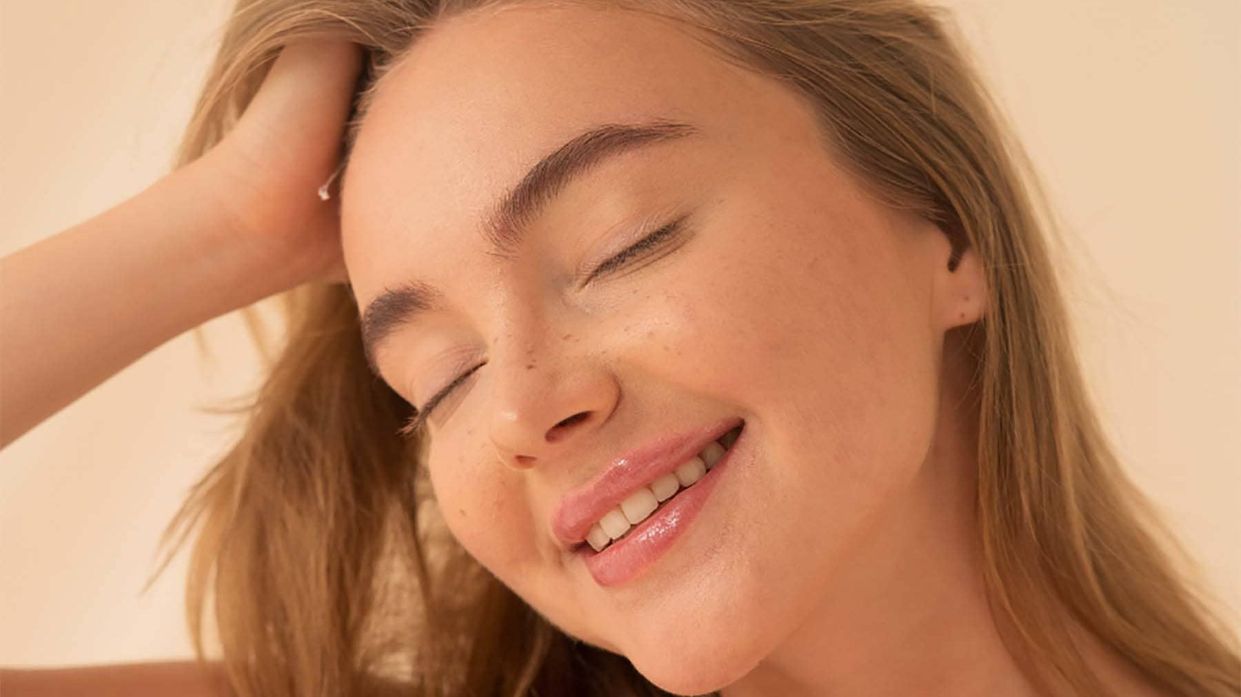 Woman enjoying new hairstyle with Neuma's clean haircare products